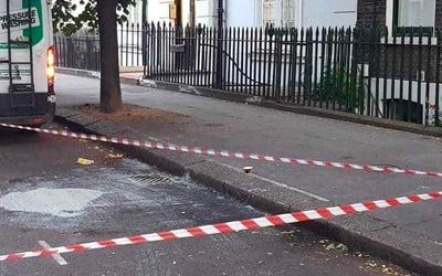 A commercial cleaning truck is parked on the side of a street.